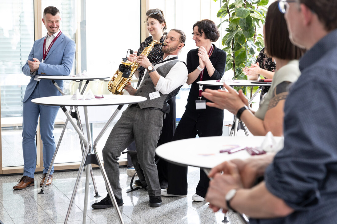 Ein Saxophonist spielt, das Publikum klatscht begeistert.